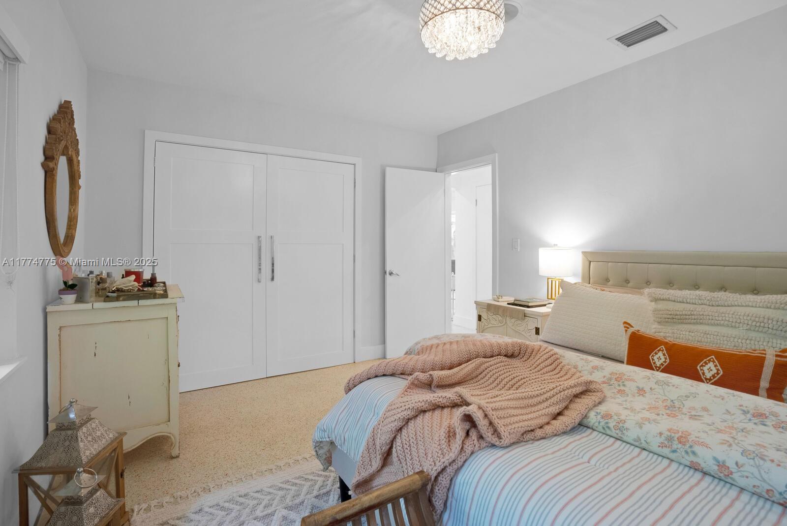 1523 Blue Road Coral Gables, FL 33146 - Photo 14 of 26 a bedroom with a bed and a mirror