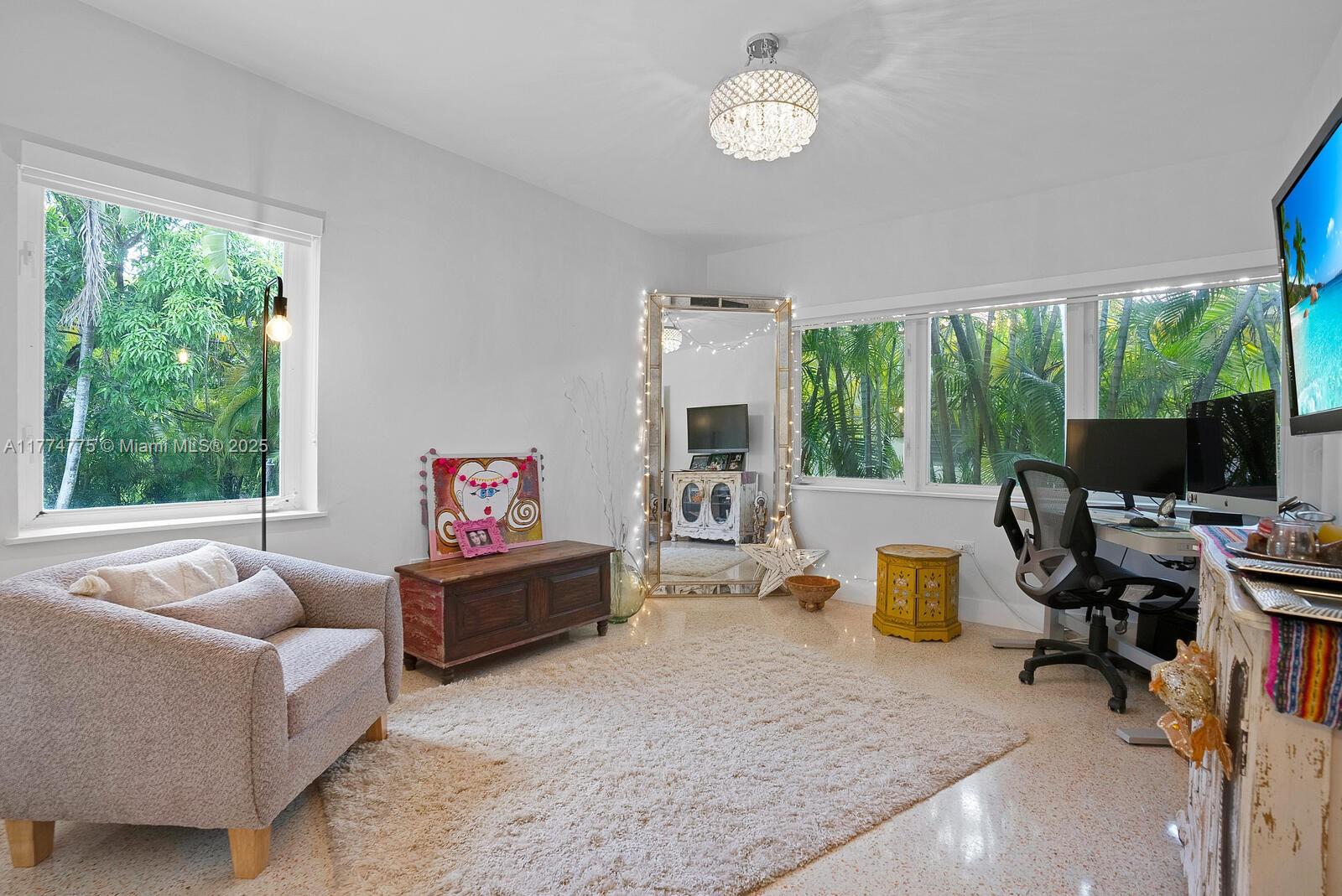 1523 Blue Road Coral Gables, FL 33146 - Photo 16 of 26 a living room with furniture a flat screen tv and a large window