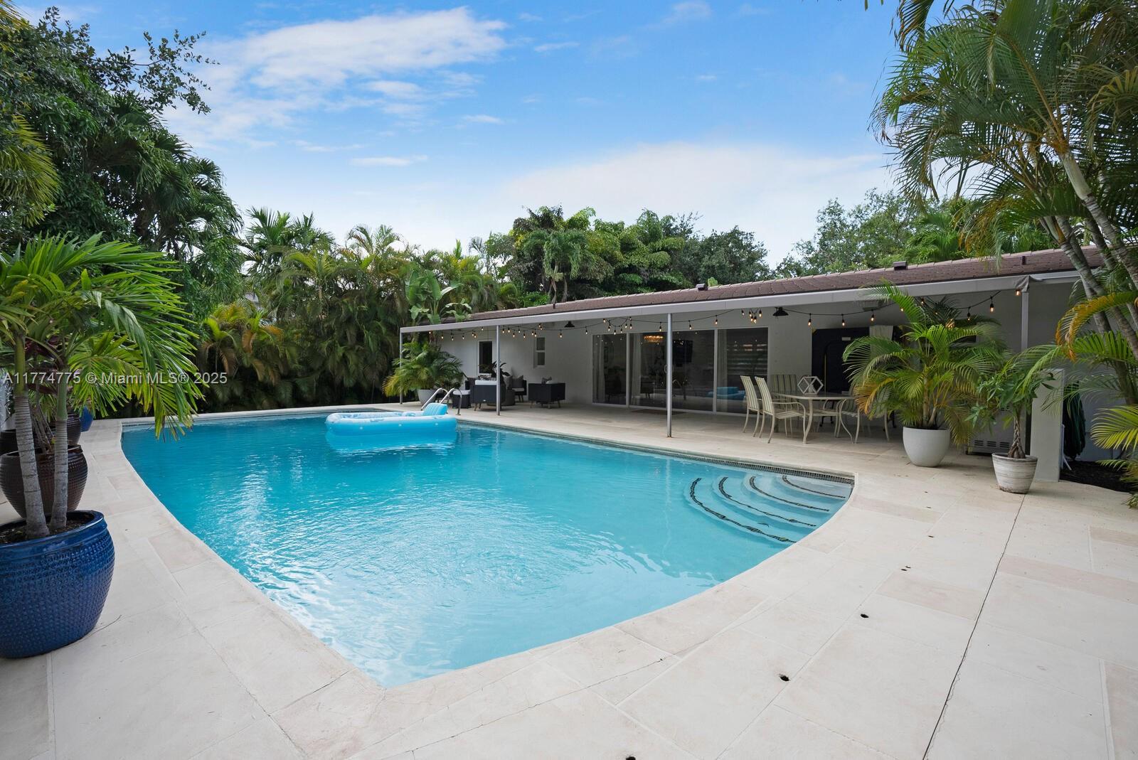 1523 Blue Road Coral Gables, FL 33146 - Photo 17 of 26 an outdoor view of house with swimming pool
