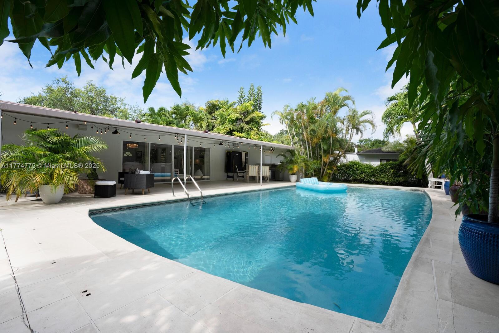 1523 Blue Road Coral Gables, FL 33146 - Photo 18 of 26 an outdoor view with swimming pool and outdoor seating