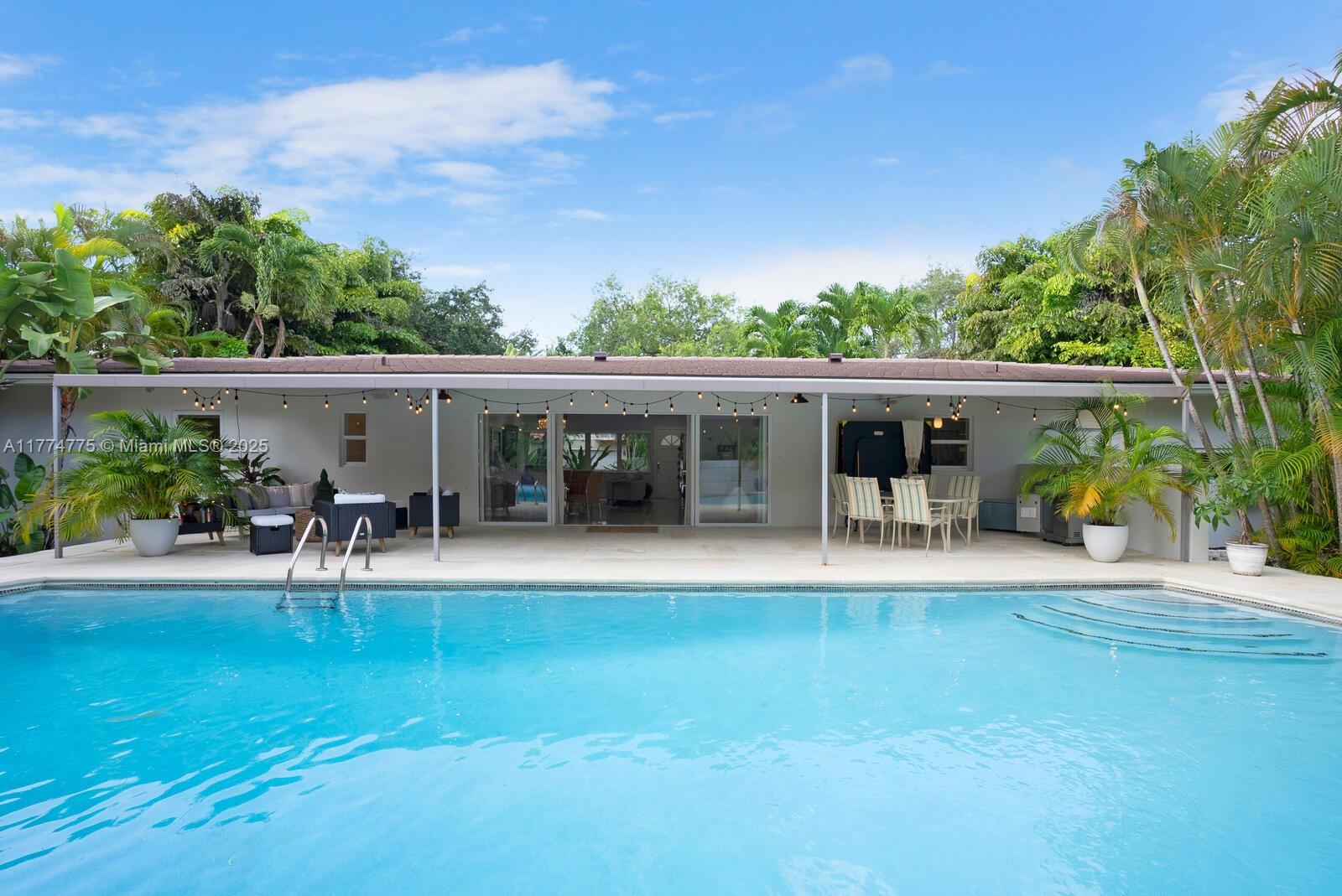 1523 Blue Road Coral Gables, FL 33146 - Photo 19 of 26 front view of a house with a patio
