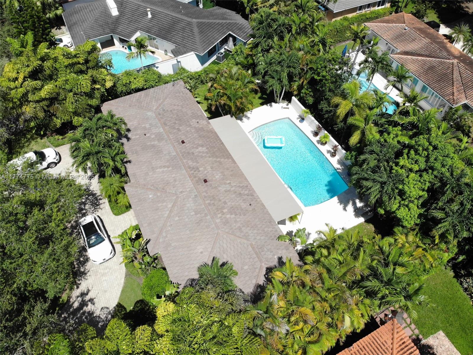 1523 Blue Road Coral Gables, FL 33146 - Photo 25 of 26 an aerial view of a house with a yard and a garden