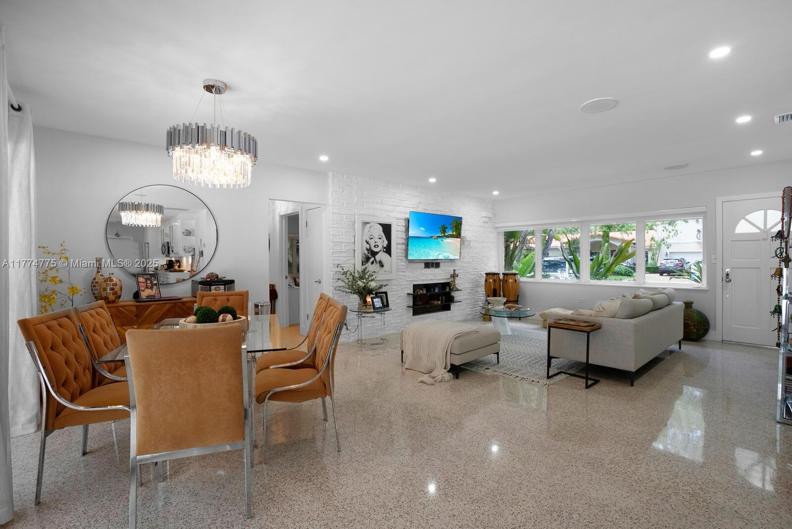 1523 Blue Road Coral Gables, FL 33146 - Photo 5 of 26 a living room with furniture and a chandelier
