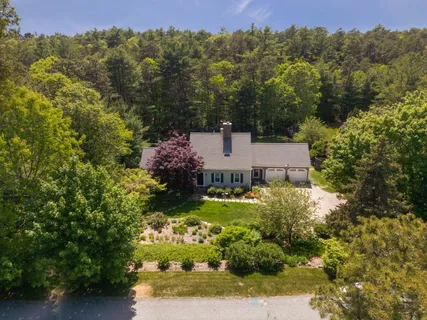 an aerial view of a house with a yard