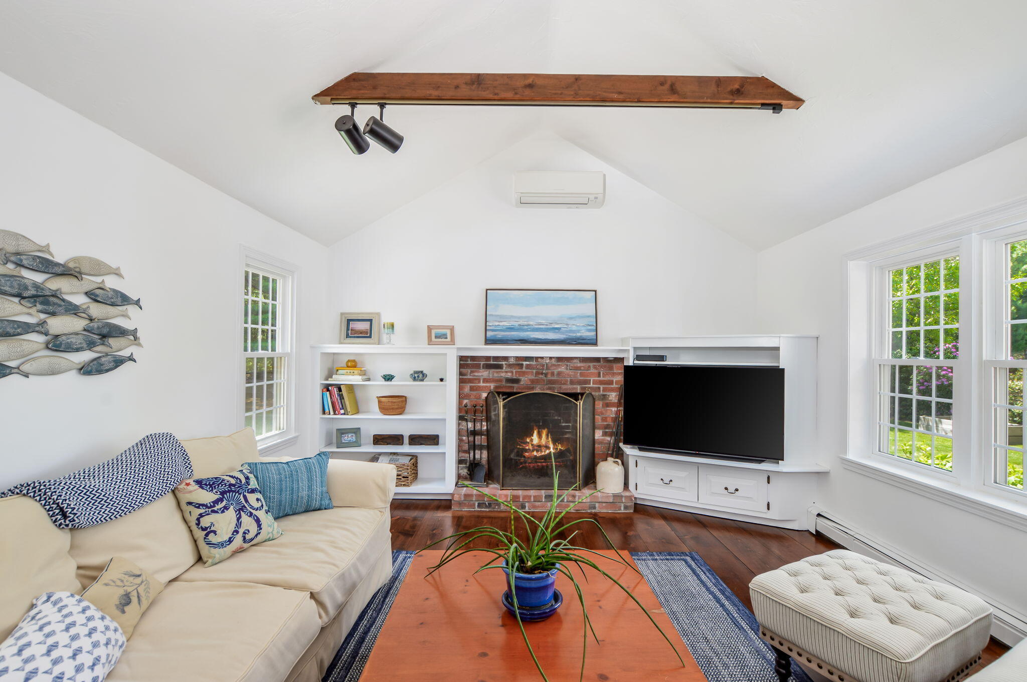 290 Cotuit Bay Drive Cotuit, MA 02635 - Photo 6 of 55 a living room with furniture a flat screen tv and a fireplace