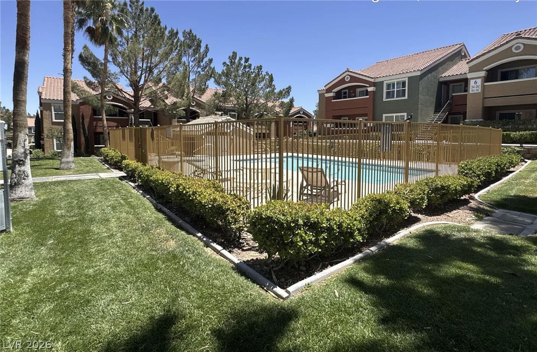 8101 West Flamingo Road, Unit 2131 Las Vegas, NV 89147 - Photo 10 of 13 A refreshing community pool with ample lounge space is securely fenced for resident enjoyment.