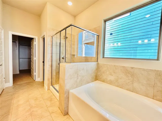 a bathroom with a bathtub and a shower