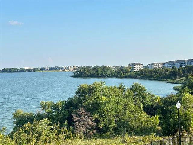 a view of a lake with houses in the back