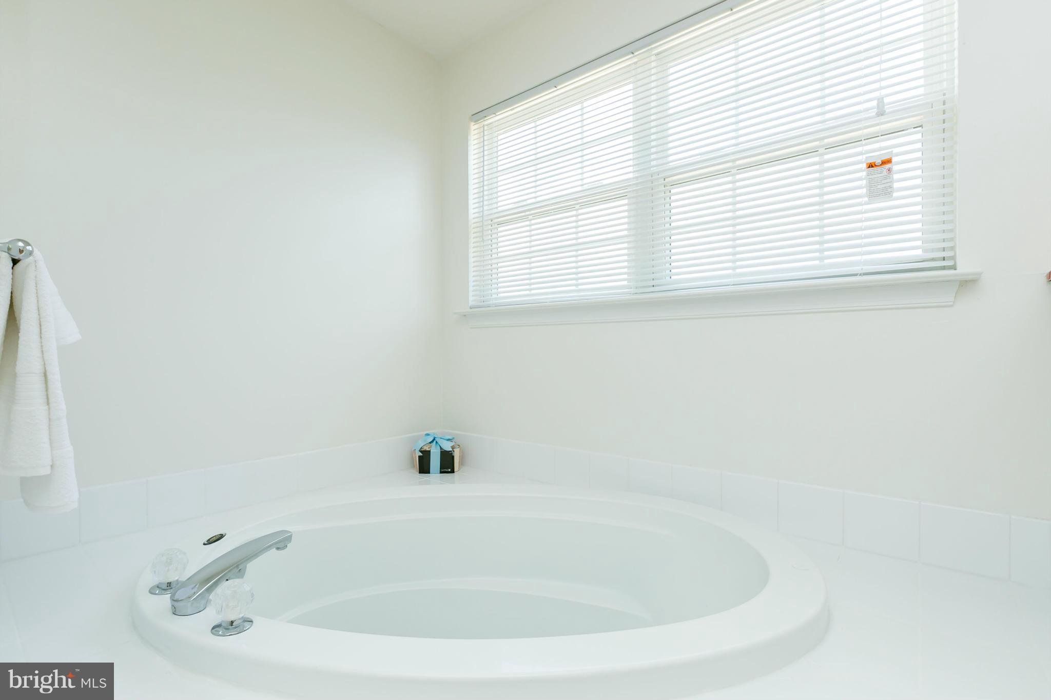 9302 Sea Point Road Baltimore, MD 21219 - Photo 18 of 30 a white bath tub sitting in a bathroom