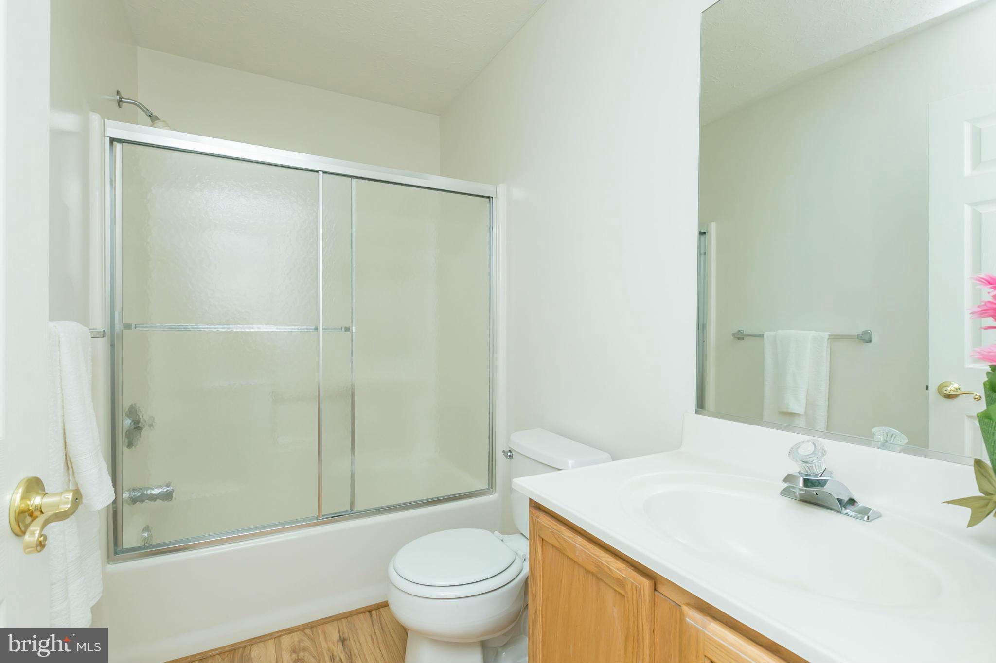 9302 Sea Point Road Baltimore, MD 21219 - Photo 20 of 30 a bathroom with a sink toilet and shower