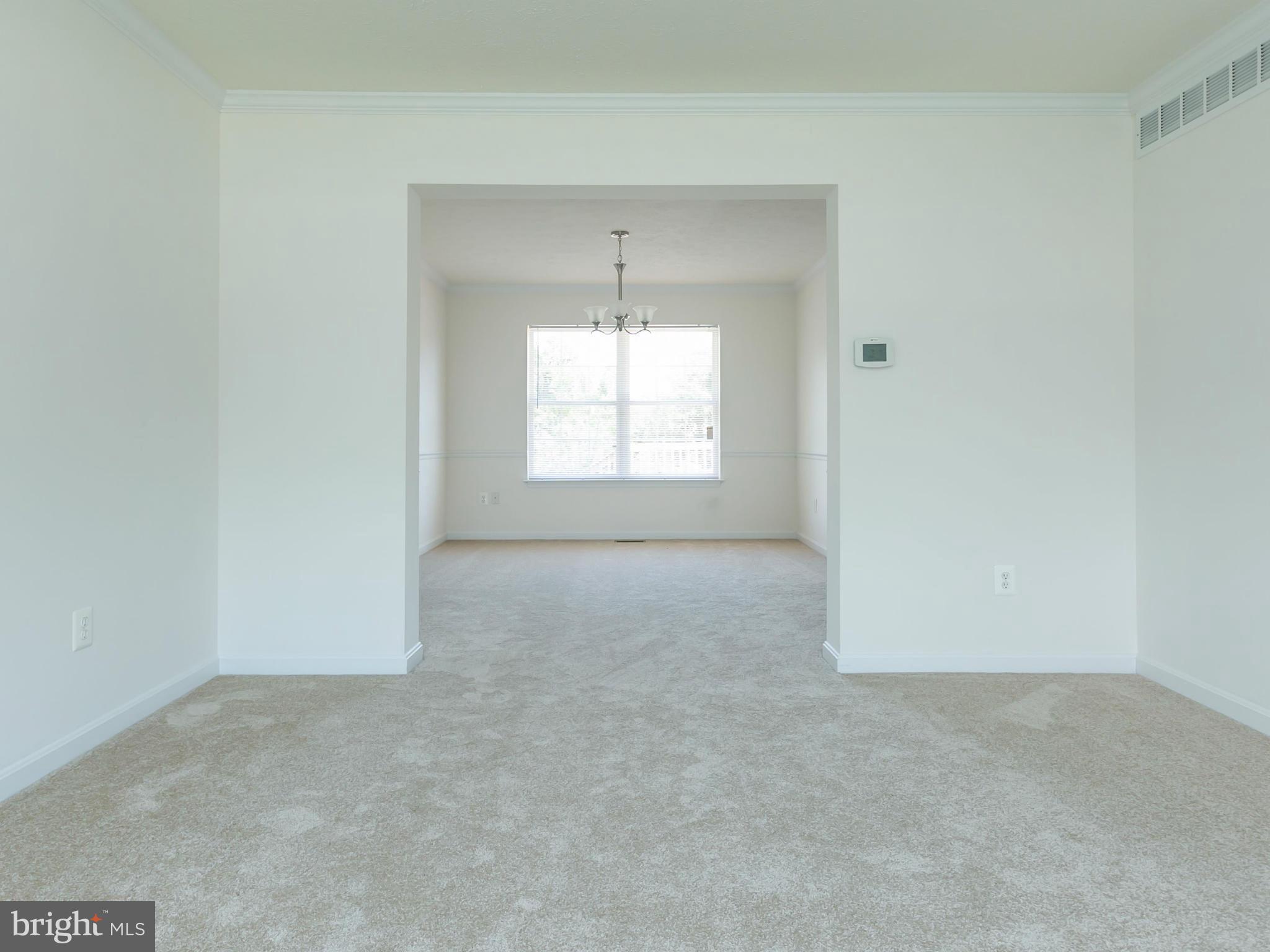 9302 Sea Point Road Baltimore, MD 21219 - Photo 3 of 30 an empty room with a window and a mirror