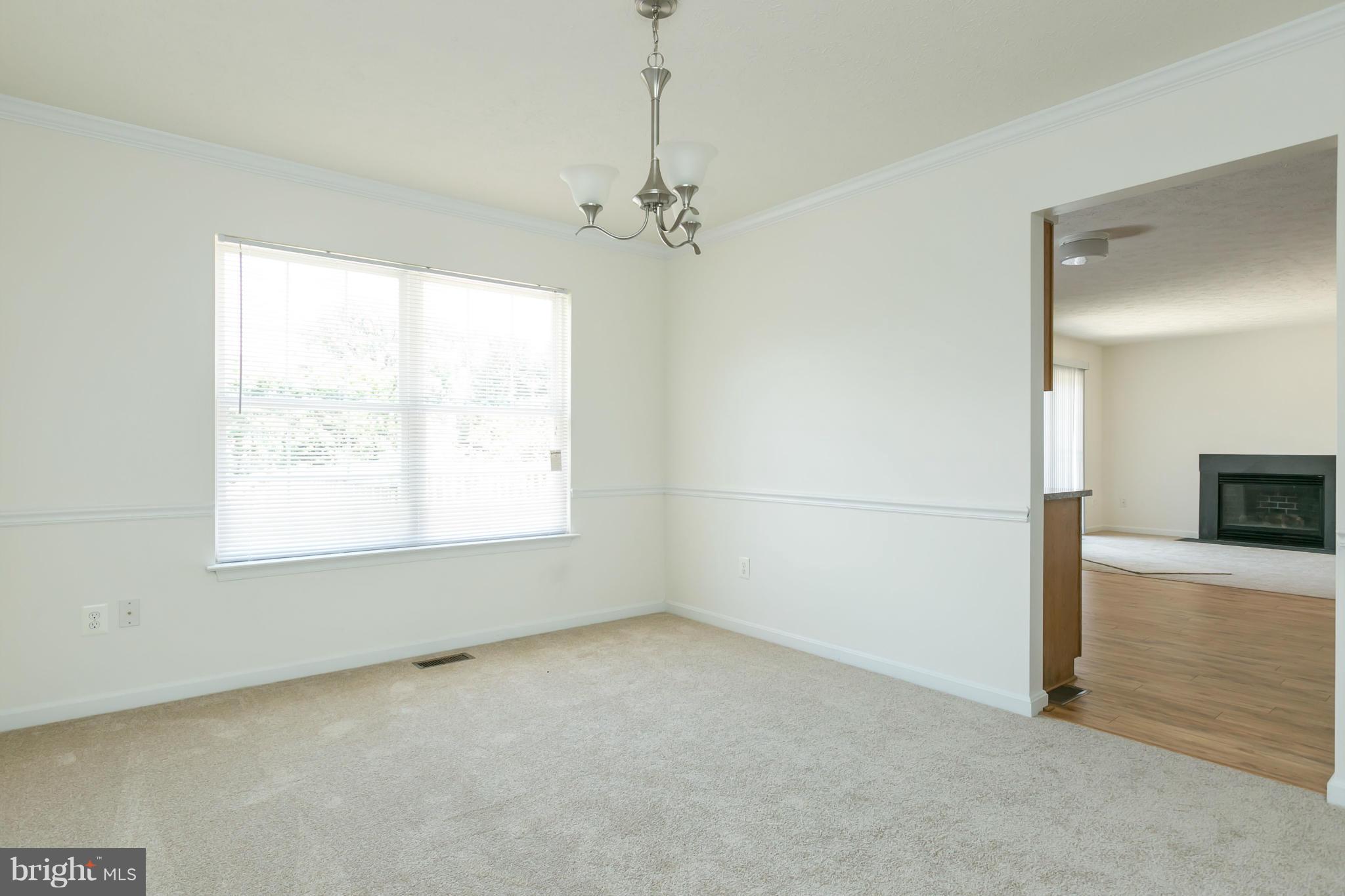9302 Sea Point Road Baltimore, MD 21219 - Photo 5 of 30 en empty room with windows and ceiling fan
