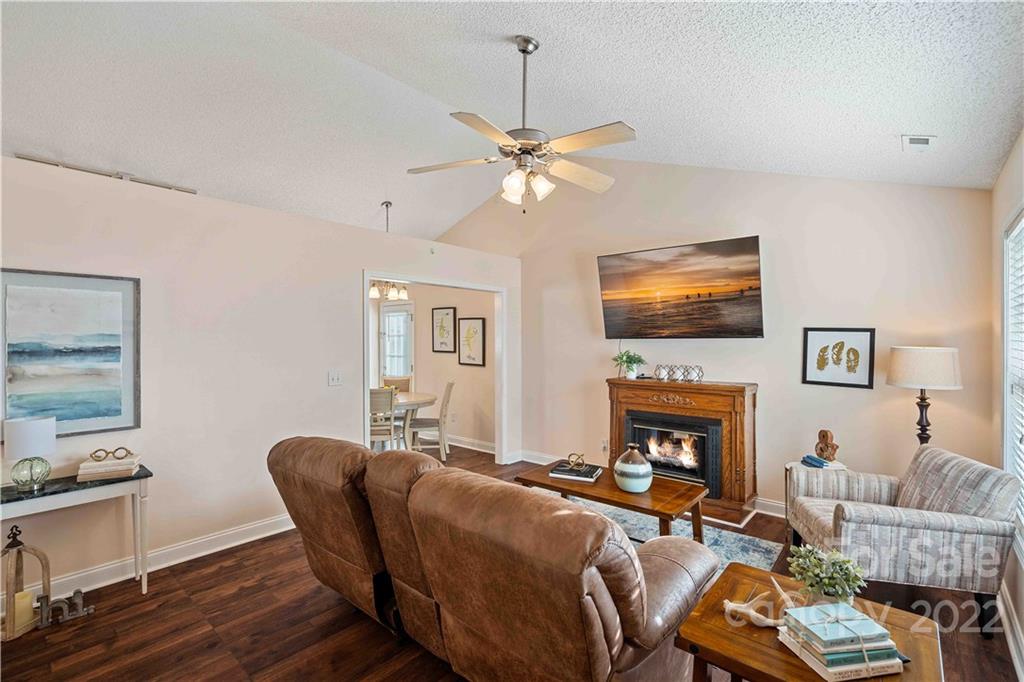 321 Dexter Place Monroe, NC 28110 - Photo 2 of 17 a living room with furniture a flat screen tv and a fireplace