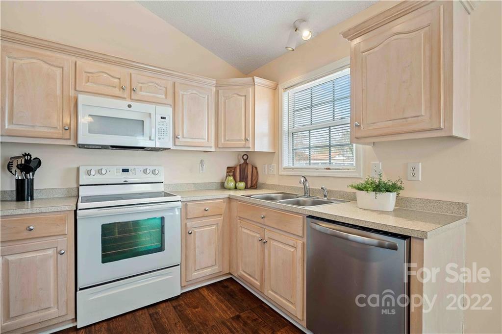 321 Dexter Place Monroe, NC 28110 - Photo 7 of 17 a kitchen with stainless steel appliances granite countertop a sink stove and cabinets