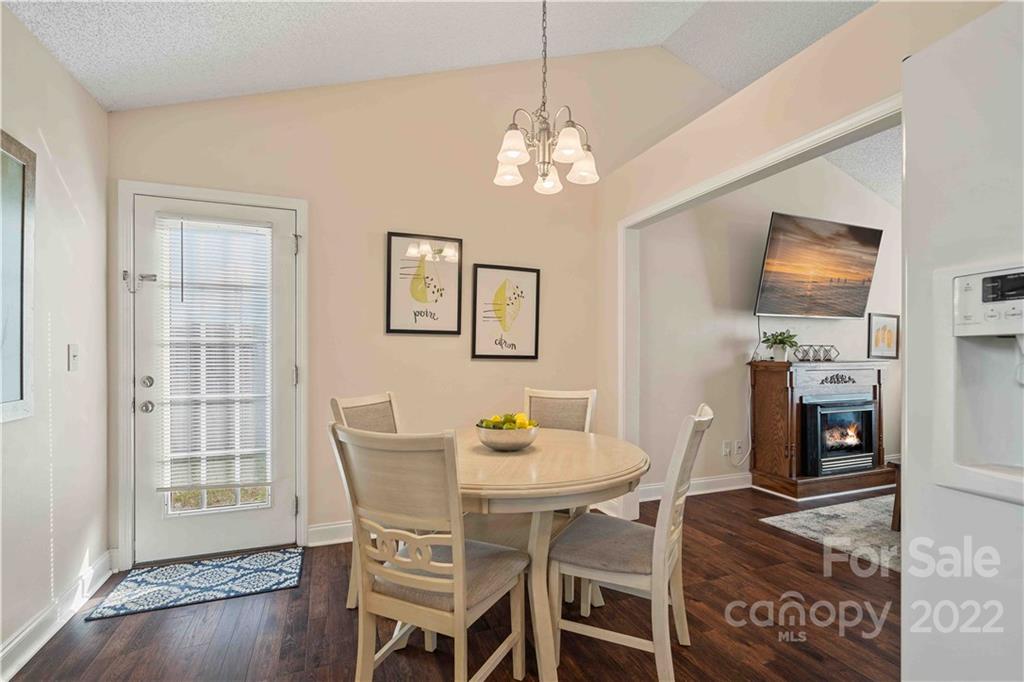 321 Dexter Place Monroe, NC 28110 - Photo 8 of 17 a view of a dining room with furniture wooden floor and chandelier