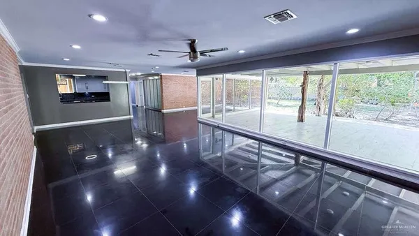 a view of a livingroom with wooden floor and a ceiling fan