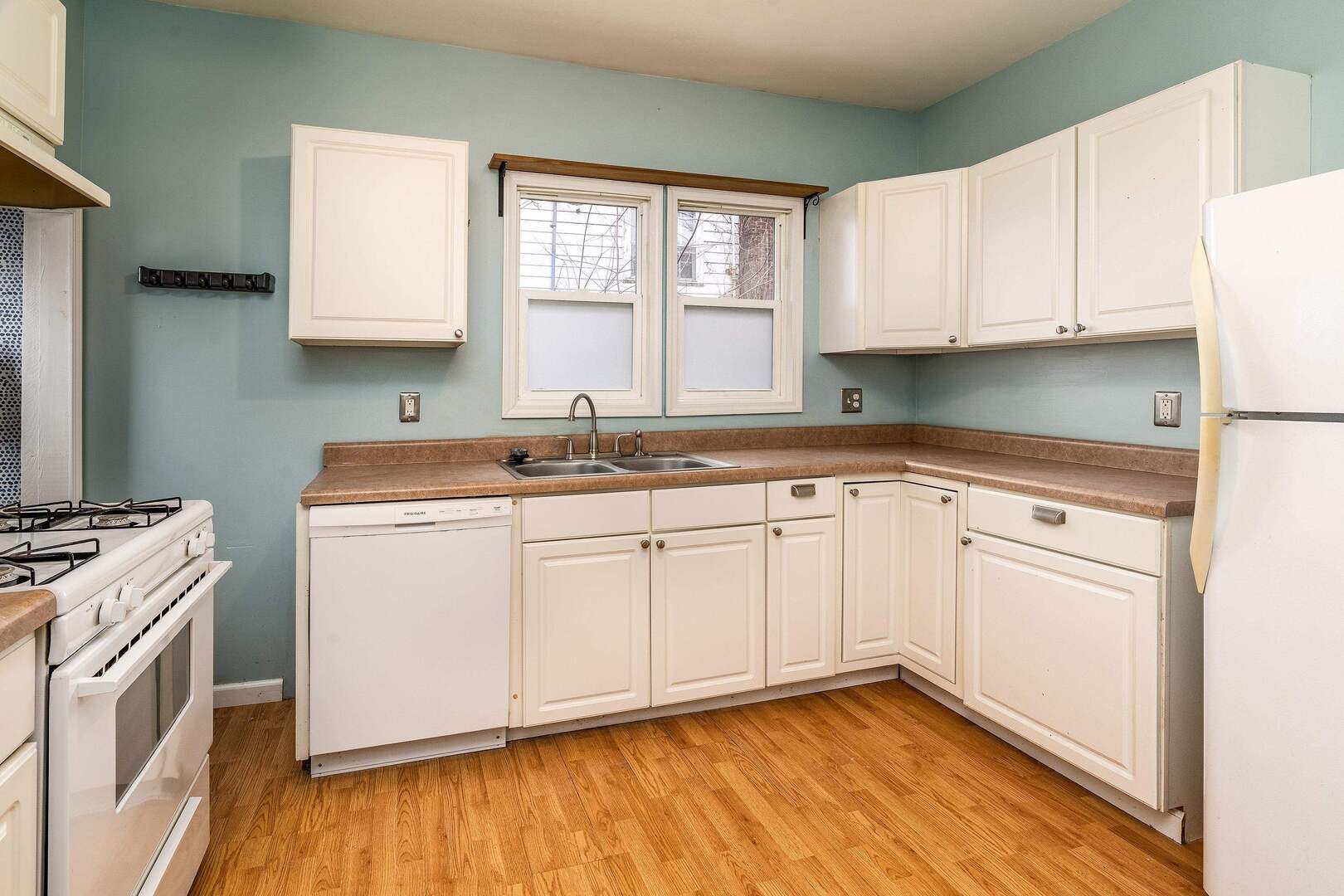 705 North Bridge Street Carbondale, IL 62901 - Photo 12 of 29 a kitchen with granite countertop white cabinets sink and white appliances