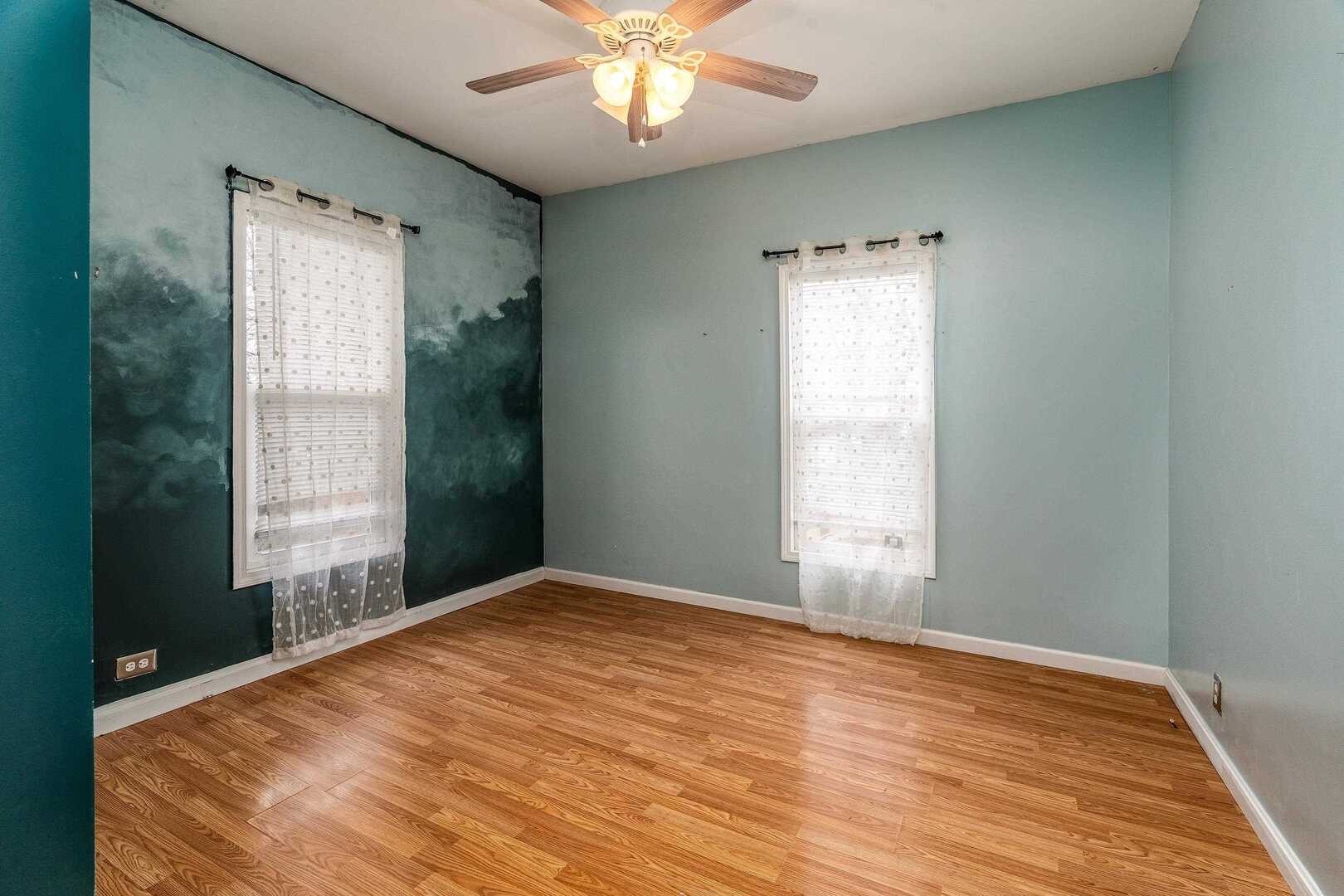 705 North Bridge Street Carbondale, IL 62901 - Photo 14 of 29 a view of an empty room with wooden floor and a window