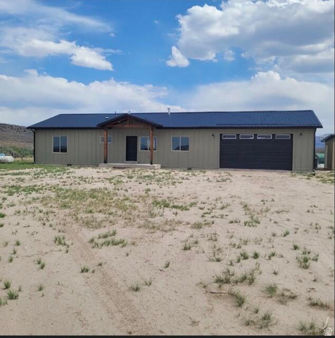 9381 South Sevier Riv Ranch Levan, UT 84639 - Photo 2 of 58 Single-story residence featuring a dark metal roof, light-colored siding, and a covered entry
