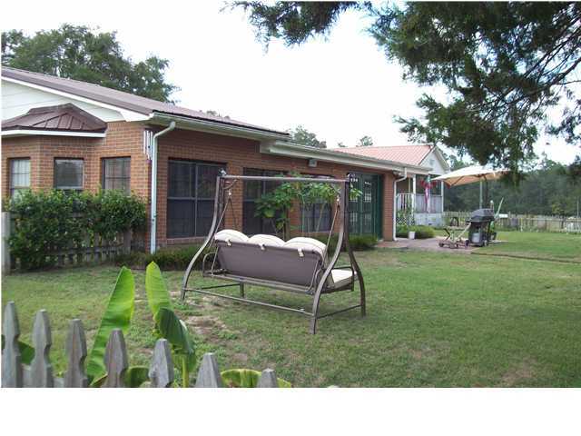 6023 Dairy Road Baker, FL 32531 - Photo 19 of 29 a backyard of a house with table and chairs