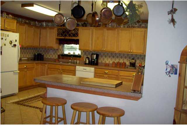 6023 Dairy Road Baker, FL 32531 - Photo 3 of 29 a kitchen with a table and chairs