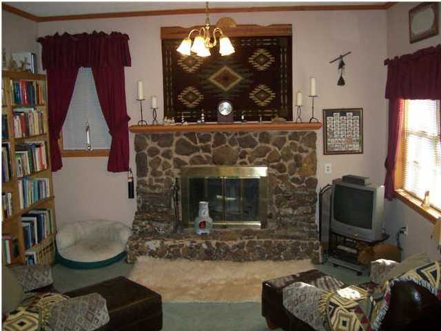 6023 Dairy Road Baker, FL 32531 - Photo 25 of 29 a living room with furniture a fireplace and a flat screen tv