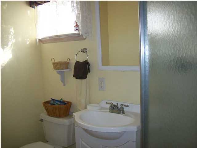 6023 Dairy Road Baker, FL 32531 - Photo 26 of 29 a bathroom with a toilet sink and mirror