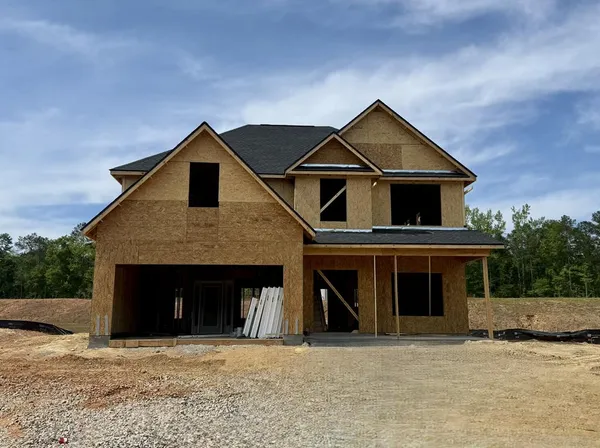 a front view of a house with yard and garage