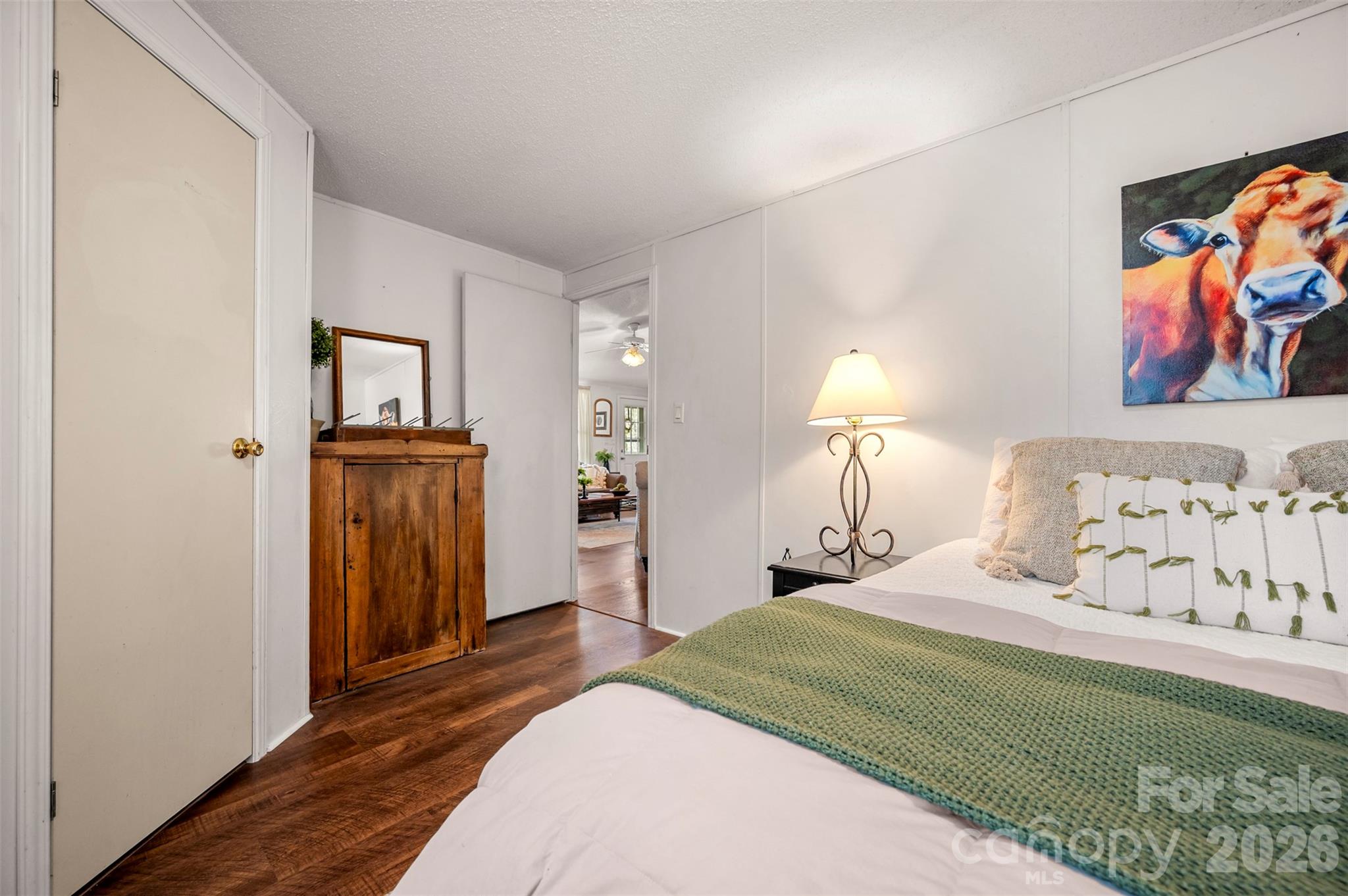 243 Buffalo Creek Road Lake Lure, NC 28746 - Photo 20 of 33 a bedroom with a bed and a painting on the wall
