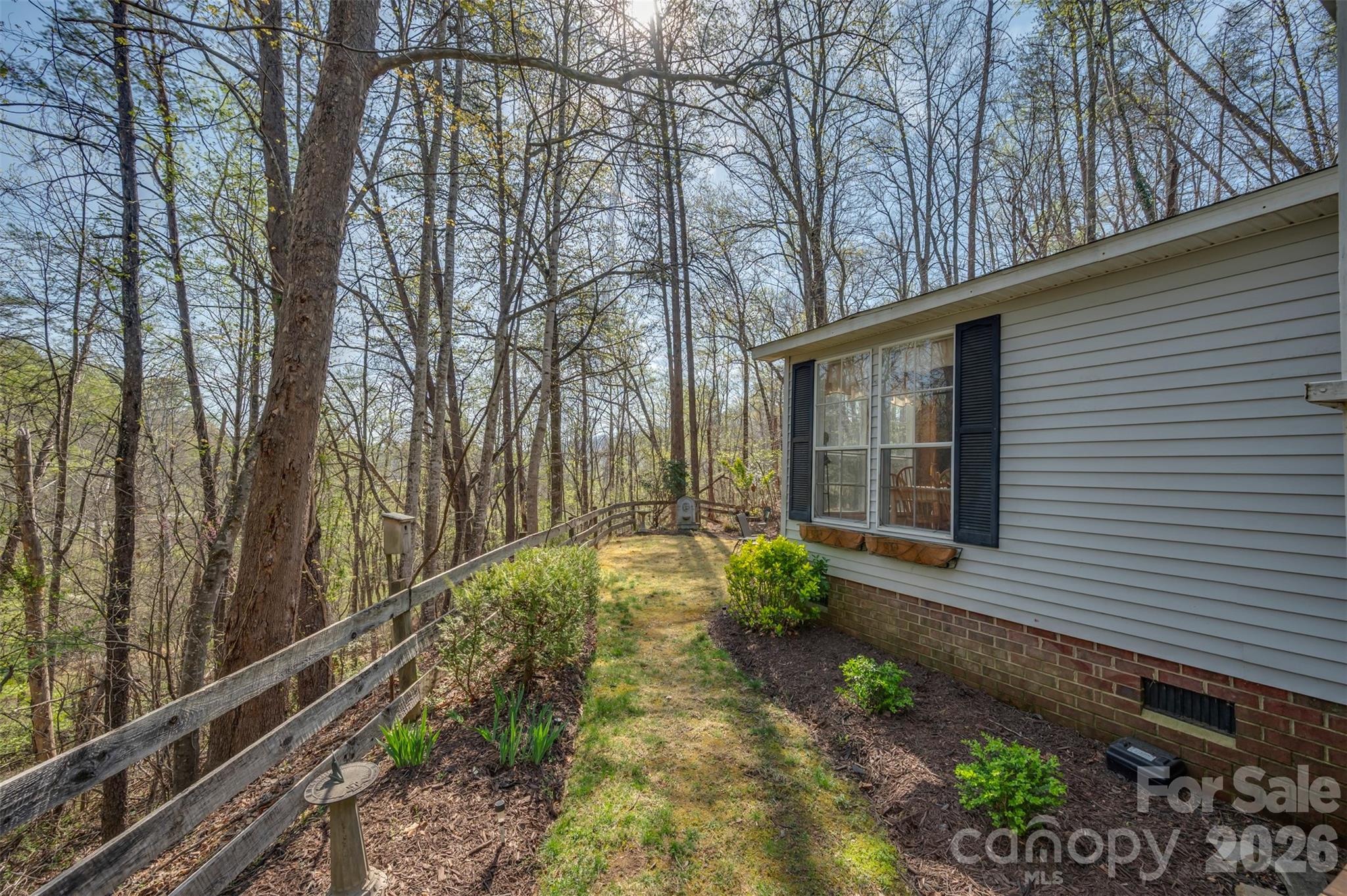 243 Buffalo Creek Road Lake Lure, NC 28746 - Photo 23 of 33 a backyard of a house with lots of green space