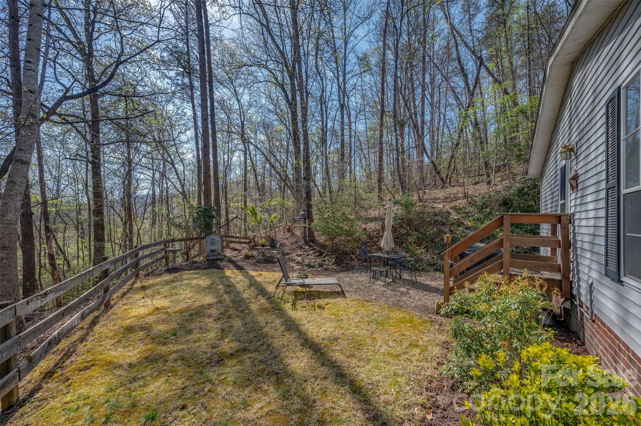 243 Buffalo Creek Road Lake Lure, NC 28746 - Photo 24 of 33 a view of a backyard with plants and large trees