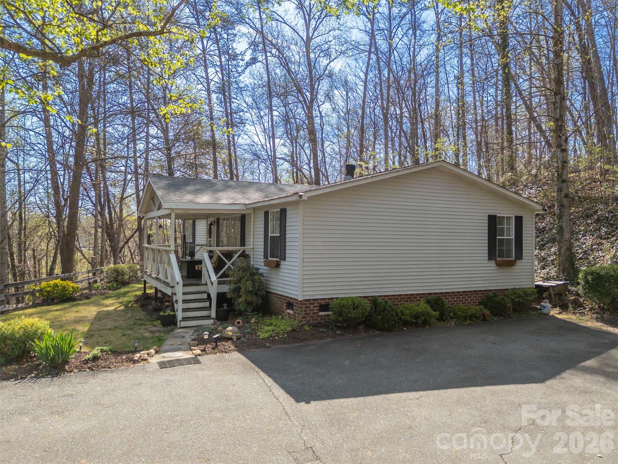 243 Buffalo Creek Road Lake Lure, NC 28746 - Photo 32 of 33 a front view of a house with garden