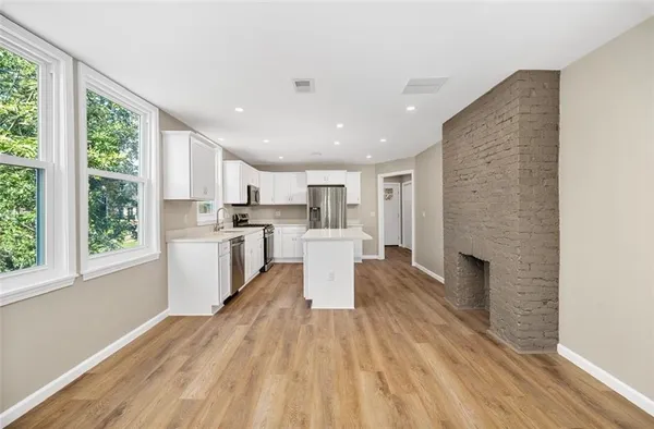 a kitchen with a white wooden cabinets and white appliances