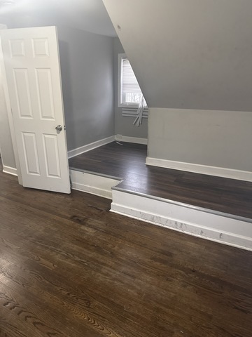 15818 St Louis Avenue Markham, IL 60428 - Photo 11 of 17 an empty room with wooden floor and windows