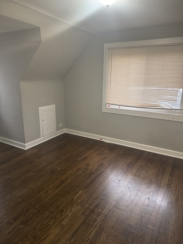 15818 St Louis Avenue Markham, IL 60428 - Photo 13 of 17 a view of a room with wooden floor and brick walls