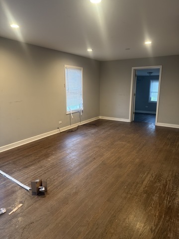 15818 St Louis Avenue Markham, IL 60428 - Photo 3 of 17 an empty room with wooden floor and a window