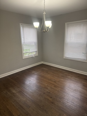 15818 St Louis Avenue Markham, IL 60428 - Photo 4 of 17 an empty room with wooden floor and windows