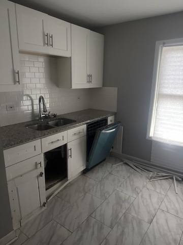 15818 St Louis Avenue Markham, IL 60428 - Photo 5 of 17 a kitchen with granite countertop white cabinets and white appliances