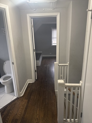 15818 St Louis Avenue Markham, IL 60428 - Photo 9 of 17 a view of a hallway with wooden floor and staircase
