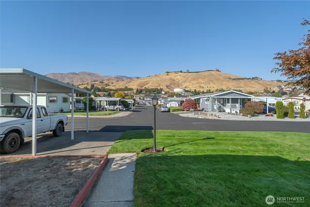 a view of a house with a yard deck and a garden