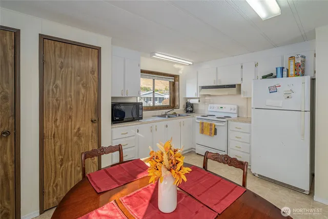 a living room with furniture a flat screen tv and a table