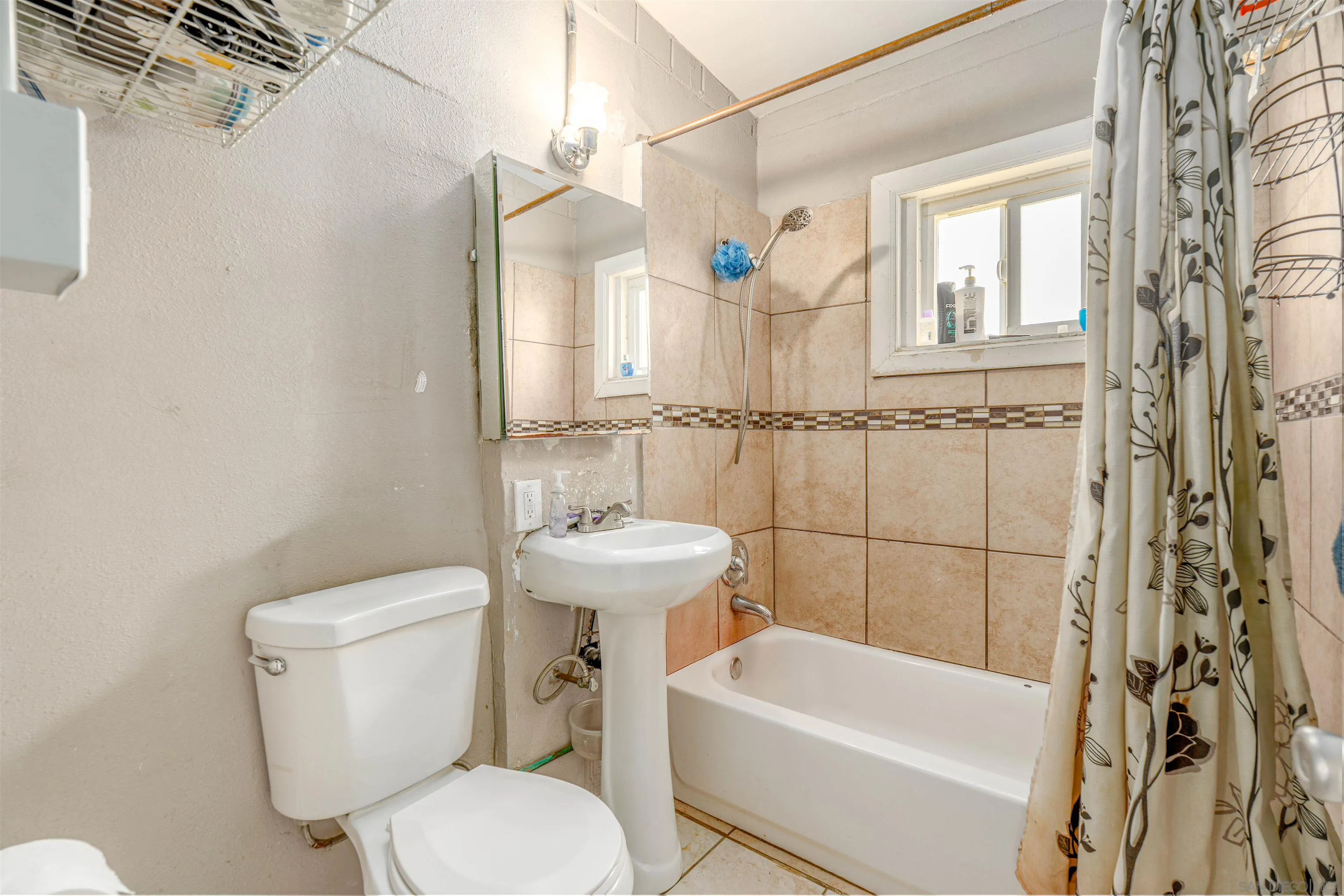 28587 Goetz Road Canyon Lake, CA 92587 - Photo 11 of 24 a white toilet sitting next to a bathroom sink