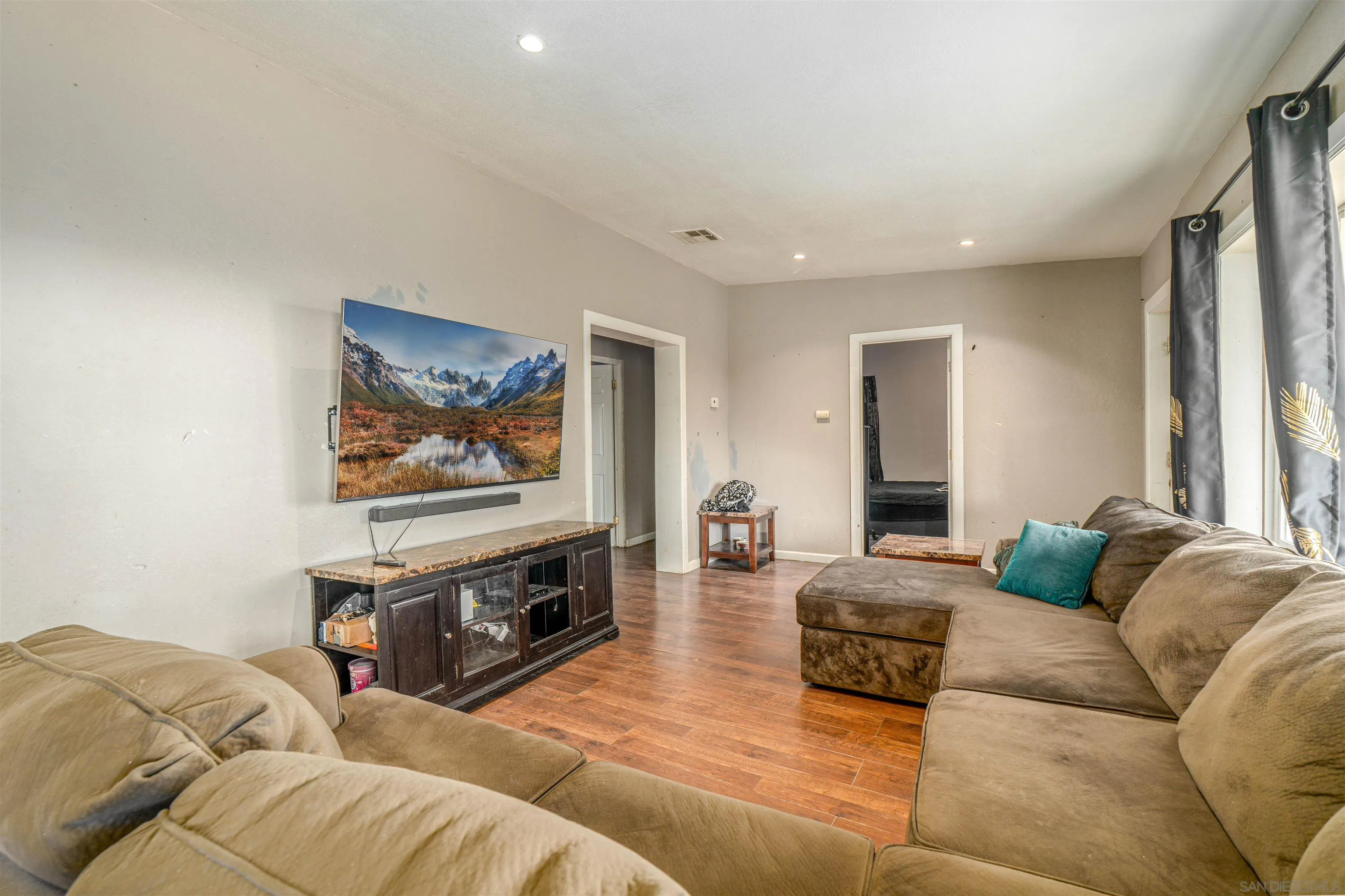 28587 Goetz Road Canyon Lake, CA 92587 - Photo 10 of 24 a living room with furniture a couch and a flat screen tv