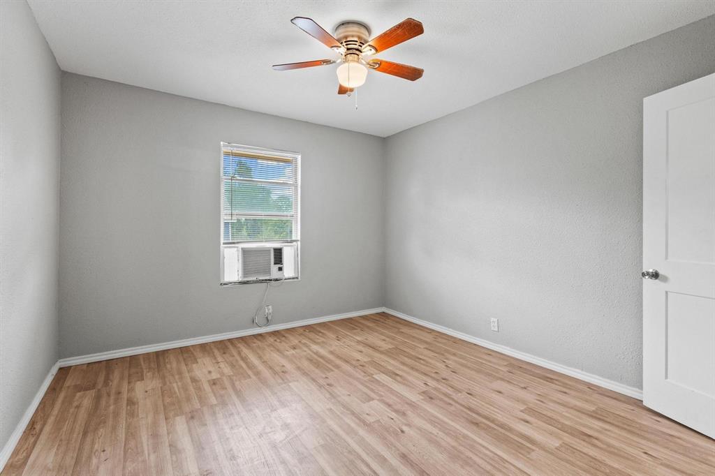 701 West Hull Street, Unit 1012 Denison, TX 75020 - Photo 11 of 22 wooden floor in an empty room with a window