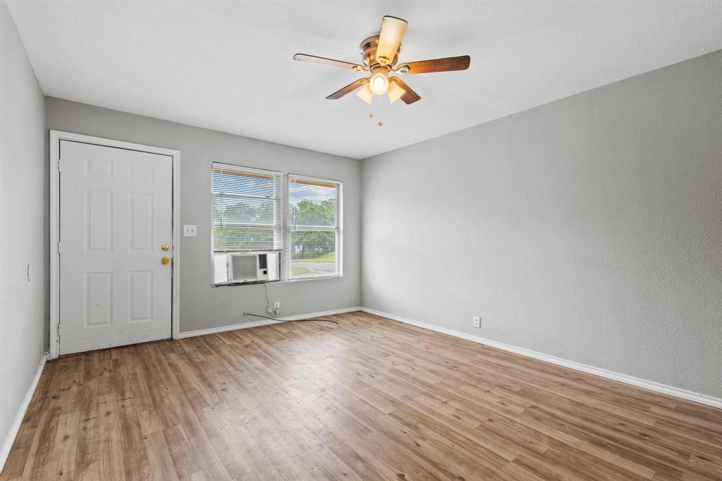 701 West Hull Street, Unit 1012 Denison, TX 75020 - Photo 6 of 22 a view of an empty room with window and a kitchen
