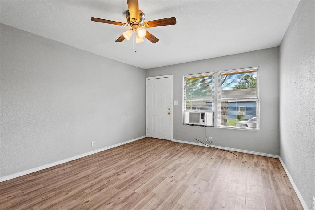 701 West Hull Street, Unit 1012 Denison, TX 75020 - Photo 7 of 22 a view of empty room with wooden floor and fan