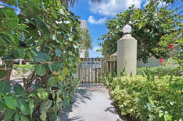 225 South Beach Road, Unit 105 Tequesta, FL 33469 - Photo 12 of 16 a view of a house with a yard and plant