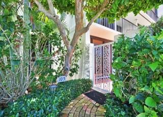 225 South Beach Road, Unit 105 Tequesta, FL 33469 - Photo 2 of 16 a view of a wooden door and trees
