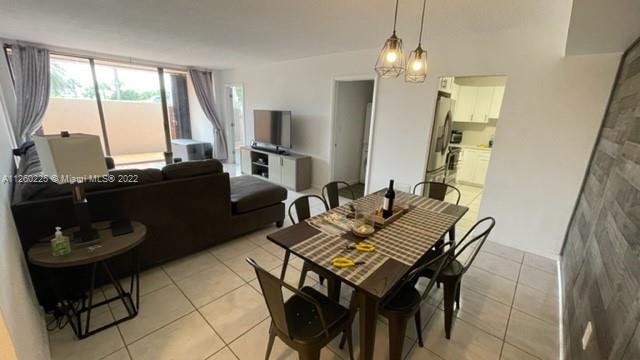 225 South Beach Road, Unit 105 Tequesta, FL 33469 - Photo 4 of 16 a view of a dining room with furniture and a chandelier