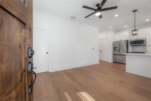 a view of a kitchen with a sink and stainless steel appliances